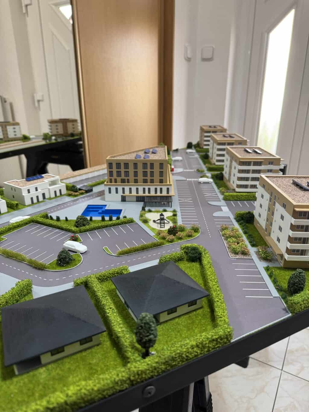 Modelové sídlisko s modernými budovami, parkoviskami a zeleňou, 3D maketa.